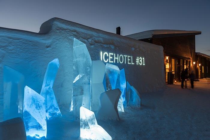 the sign outside icehotel #31 with artistic abstract ice shapes outsite.