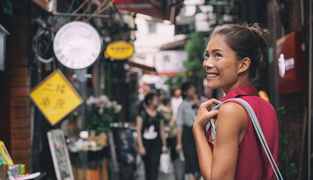 Young expat woman adventuring in streets