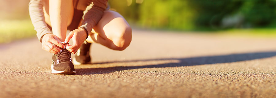 Runner tying their shoelace