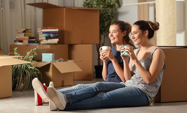 Two housemates relax after moving house