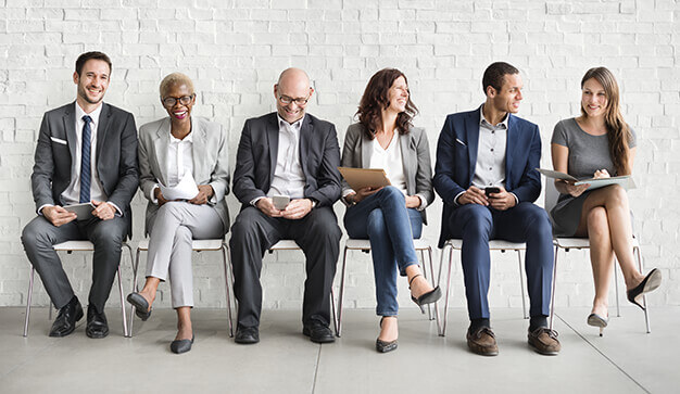 Group of diverse people sat waiting for job interview