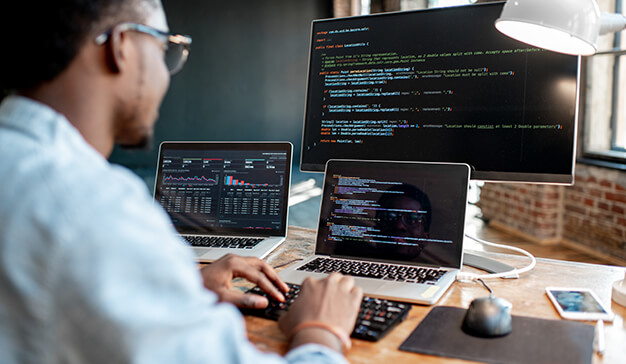 Male programmer writing program code for software or web development