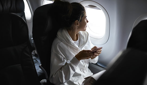 Expat on plane looking out at window