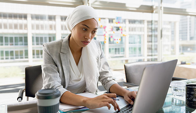 Businesswoman sat on her laptop coders and programmers in Dubai