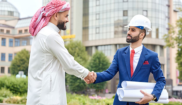 Civil engineer shaking hands with man in UAE