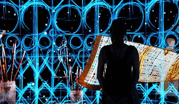 Woman sat in front of digital art at the Dubai expo