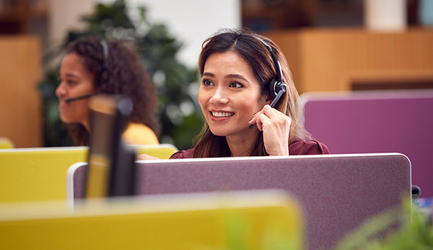 Customer services wearing headset and talking on the phone in the UAE