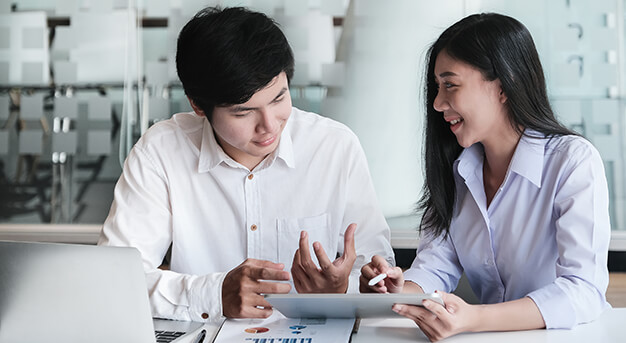 Colleagues looking at investment terms on a tablet