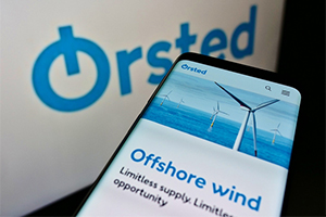 Orsted logo with phone screen displaying the Offshore Wind renewable energy