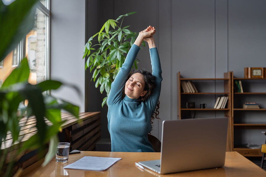 Woman stretching at her desk