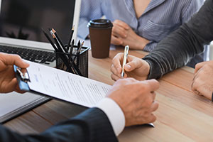 Couple signing life insurance policy