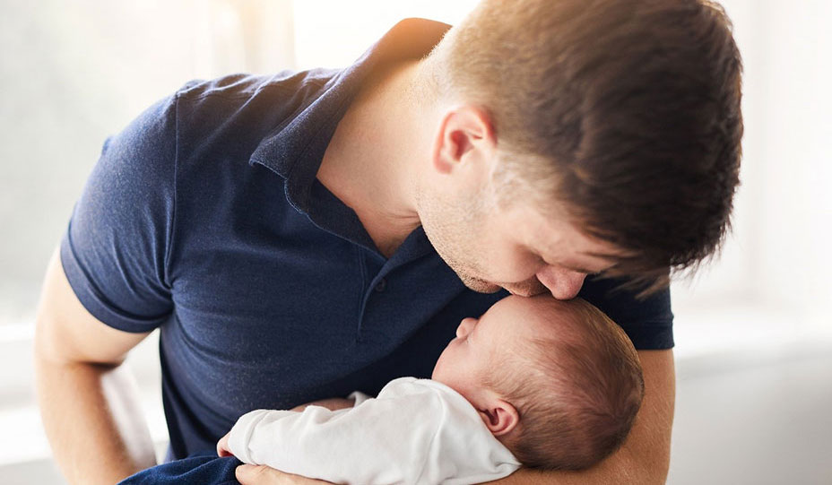 Father cradles baby