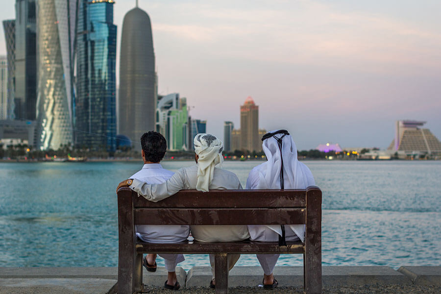 Three local men sat on a bench