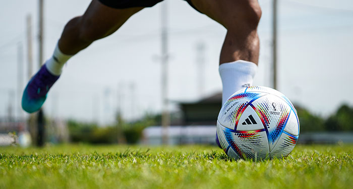 Player's foot about to kick a football