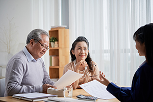 Retired couple sat in a meeting discussing important documents