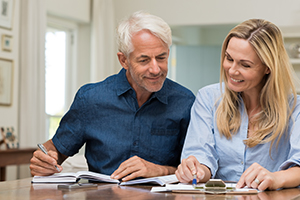 Husband and wife sat close together working finances