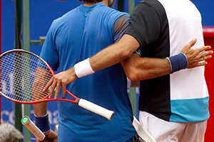 Men embracing each other after tennis match