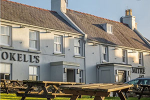 External shot of the front of The Mitre with picnic benches in front