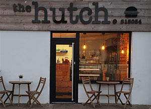External shot of the Hutch cafe front with tables outside