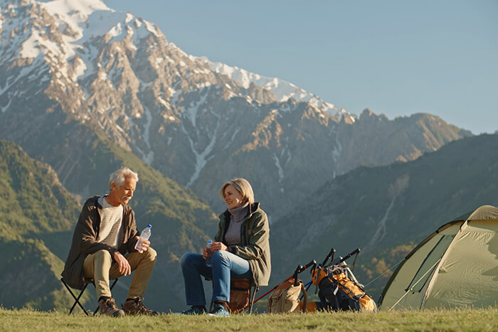 two people camping holding water bottles