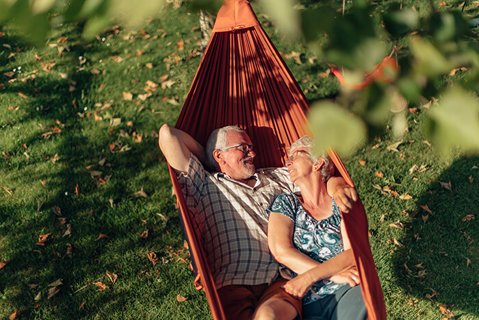 two people in a hammock looking happy