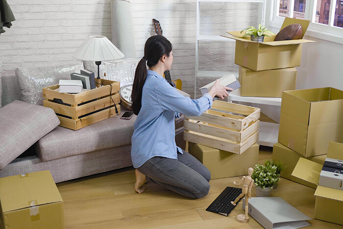 a young woman packing belongings